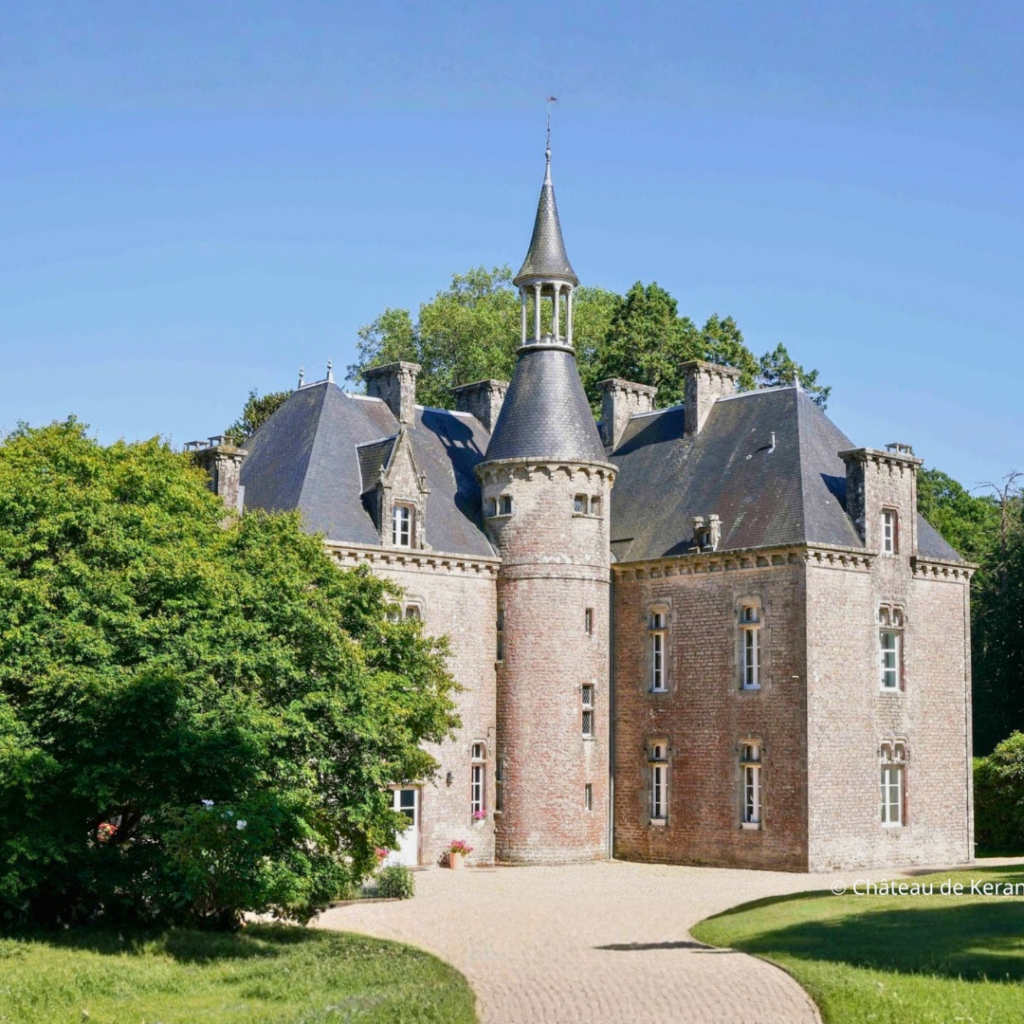 Historic castle surrounded by garden.